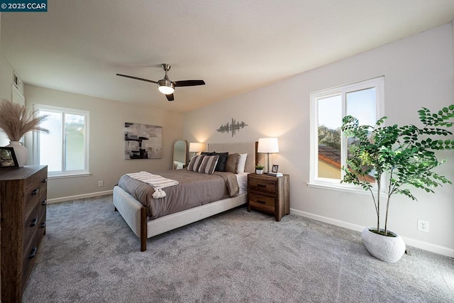 bedroom with ceiling fan, carpet flooring, and multiple windows