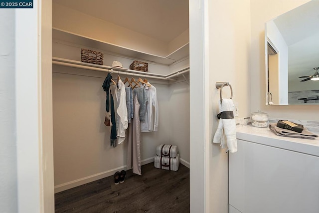 spacious closet featuring washer / dryer and dark hardwood / wood-style floors