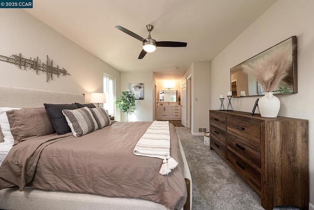 carpeted bedroom featuring ceiling fan and ensuite bath