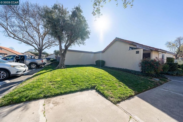 view of side of home featuring a lawn