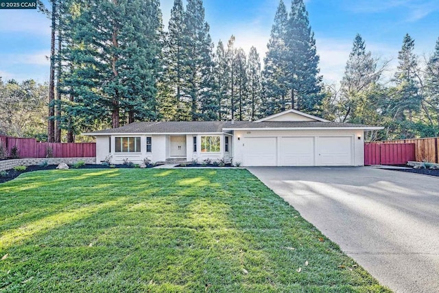 ranch-style house featuring a front yard and a garage