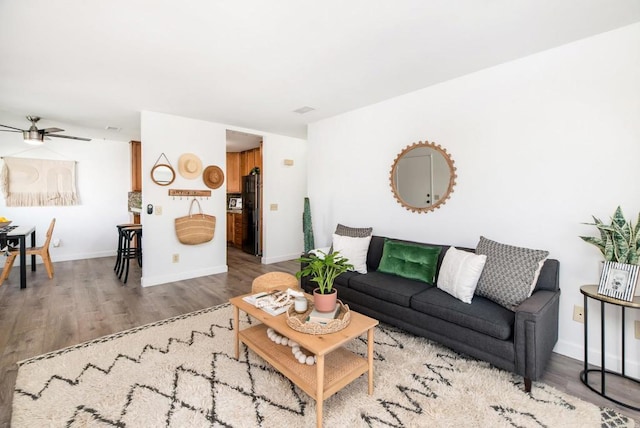 living room featuring ceiling fan and hardwood / wood-style floors