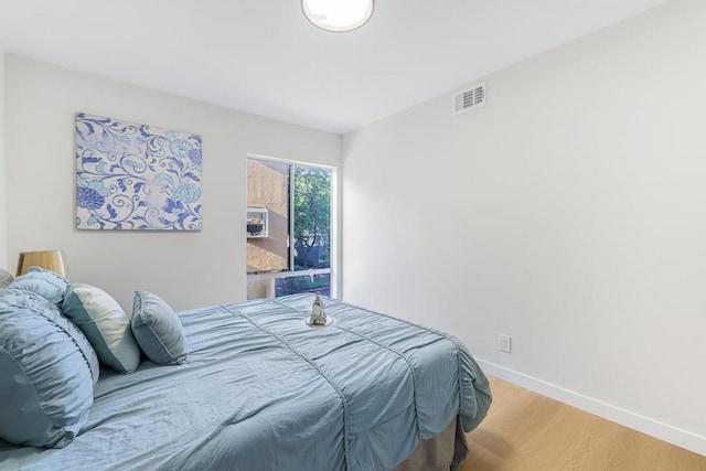 bedroom with hardwood / wood-style floors