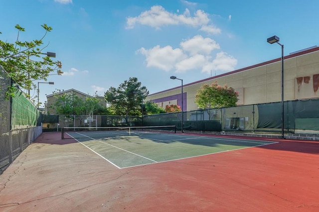 view of tennis court with basketball hoop