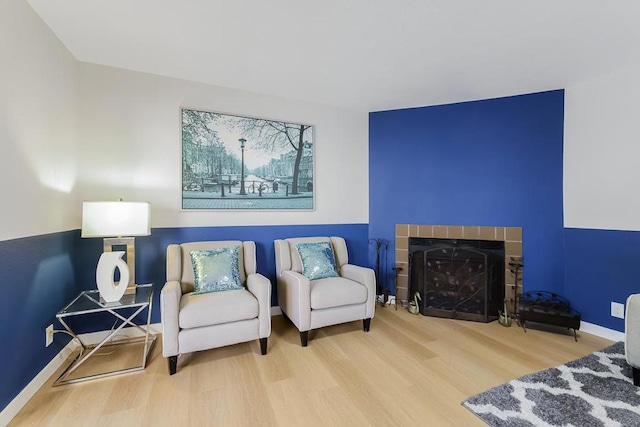 sitting room featuring hardwood / wood-style floors and a fireplace