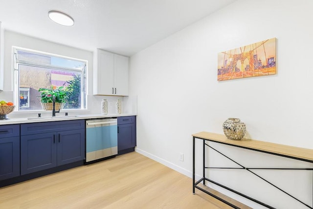 kitchen featuring sink, white cabinetry, dishwasher, light hardwood / wood-style flooring, and blue cabinetry