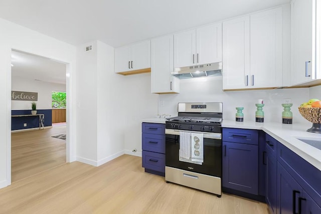 kitchen with white cabinets, light wood-type flooring, blue cabinets, and gas range