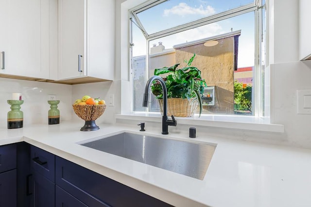 room details with sink, white cabinets, and blue cabinets