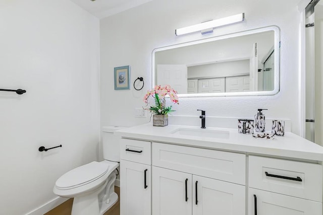 bathroom with vanity and toilet