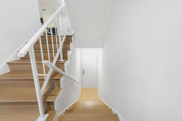 stairway featuring wood-type flooring