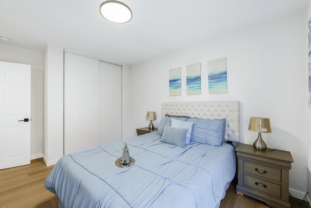 bedroom with a closet and hardwood / wood-style flooring