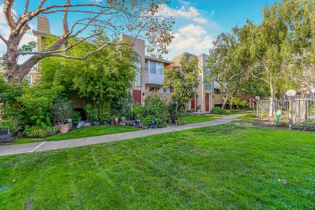 view of property's community with a lawn