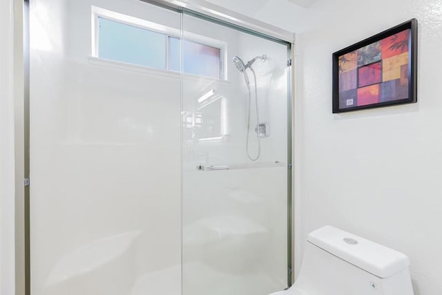 bathroom featuring toilet and a shower