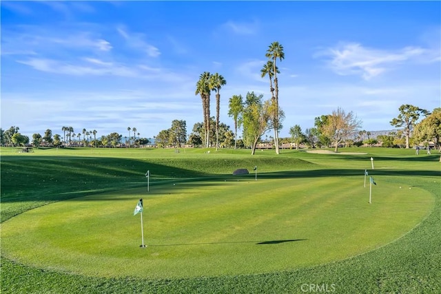 view of community featuring a yard and golf course view