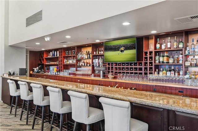 bar featuring recessed lighting, visible vents, and a bar