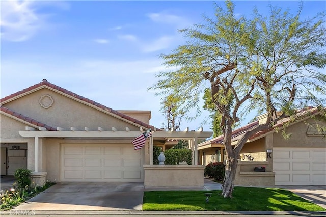 view of front of house with a garage, concrete driveway, a tiled roof, and stucco siding