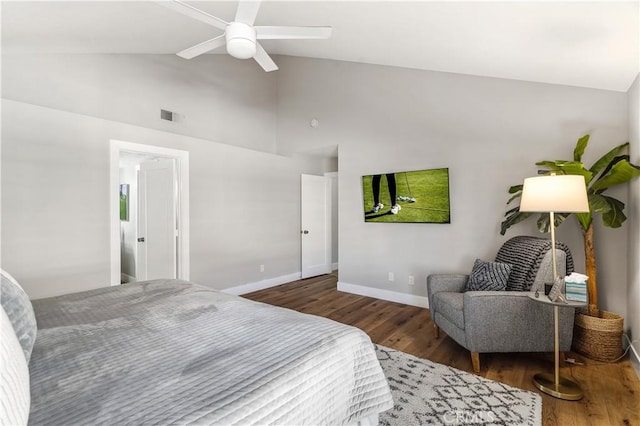 bedroom with baseboards, visible vents, ceiling fan, wood finished floors, and high vaulted ceiling