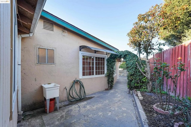 view of side of home with a patio area