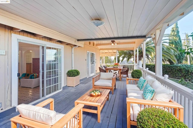 wooden deck featuring an outdoor living space and ceiling fan