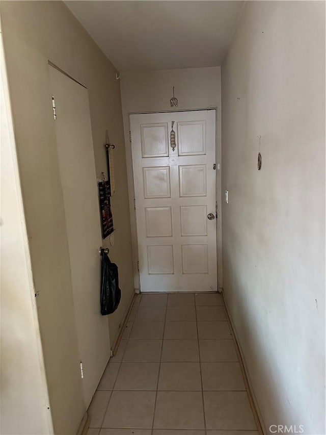 hall featuring light tile patterned flooring