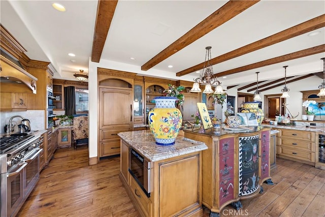 kitchen with stainless steel appliances, light hardwood / wood-style flooring, a center island, and decorative light fixtures