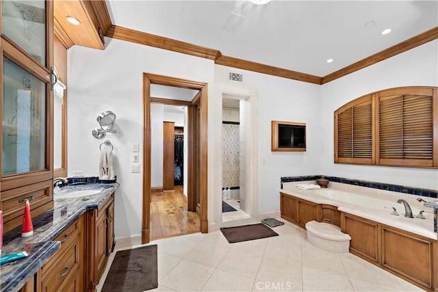 bathroom with crown molding, vanity, plus walk in shower, and tile patterned floors