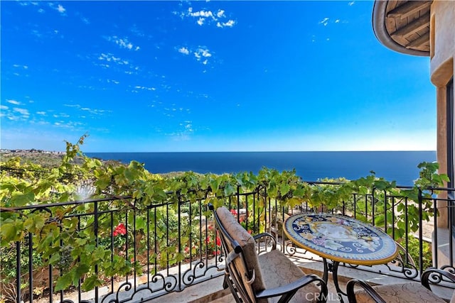 balcony featuring a water view