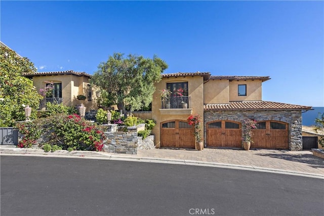 mediterranean / spanish-style house featuring a balcony and a garage