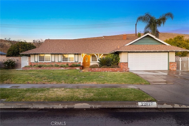 ranch-style home with a garage and a lawn