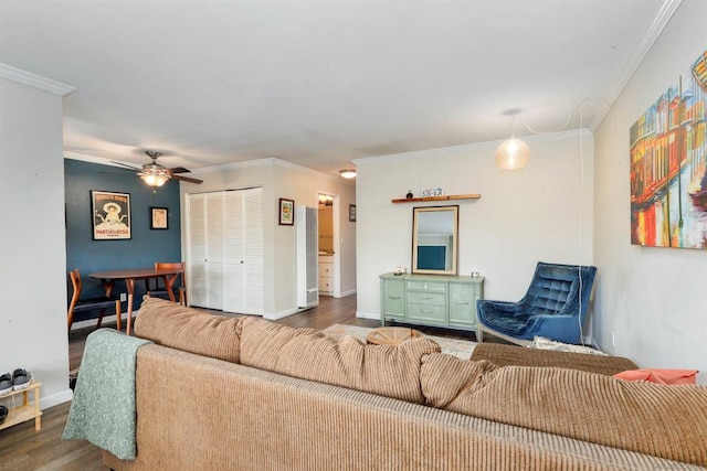 living room with ceiling fan, crown molding, and dark wood-type flooring