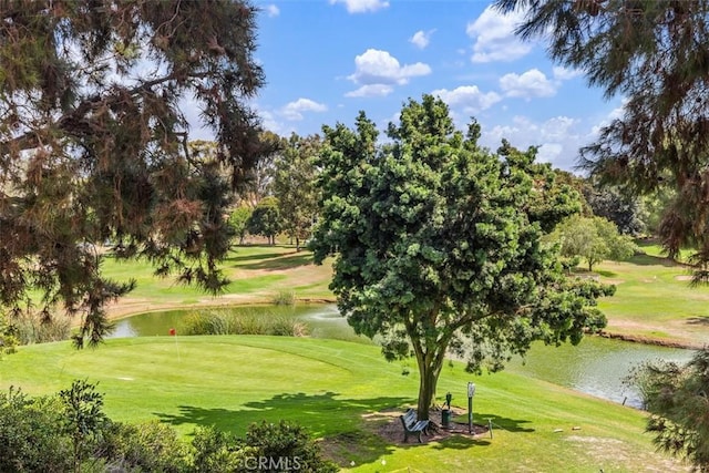 view of property's community featuring a yard and a water view