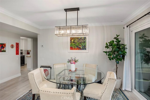 dining space featuring an inviting chandelier, crown molding, wine cooler, and light hardwood / wood-style flooring