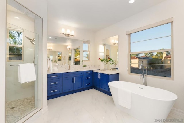 bathroom featuring separate shower and tub and vanity