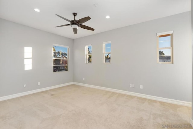 carpeted spare room with ceiling fan