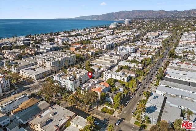 drone / aerial view with a water and mountain view