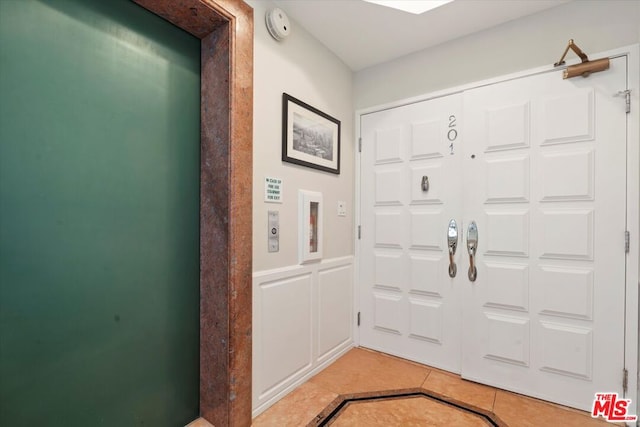 tiled foyer entrance with elevator