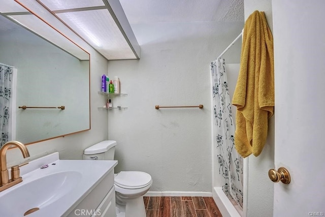 bathroom featuring vanity, toilet, and walk in shower