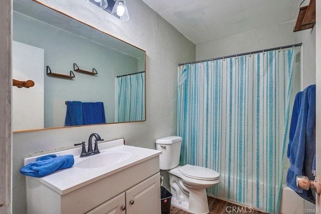 full bathroom with toilet, shower / bathtub combination with curtain, hardwood / wood-style flooring, and vanity