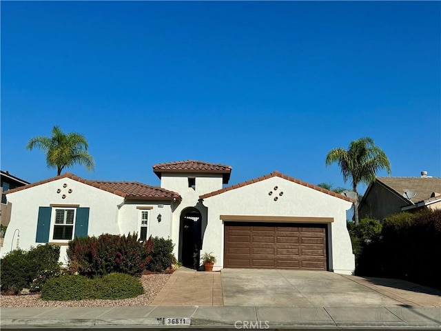 mediterranean / spanish-style home with a garage