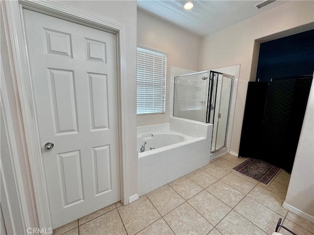 bathroom with independent shower and bath and tile patterned floors