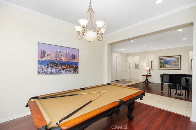 recreation room featuring pool table, ornamental molding, hardwood / wood-style flooring, and a chandelier