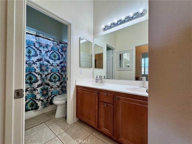 bathroom with toilet, tile patterned flooring, vanity, and curtained shower