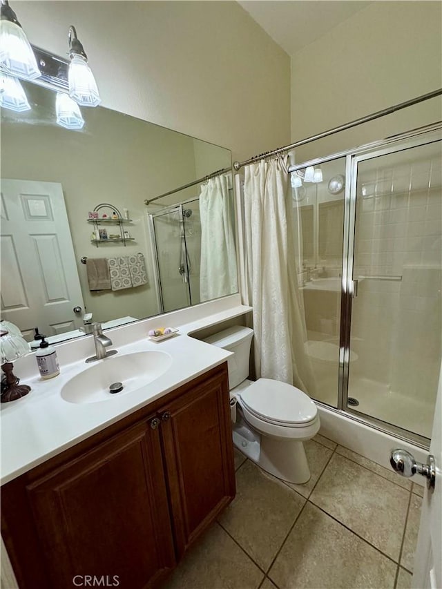 bathroom featuring walk in shower, tile patterned flooring, vanity, and toilet