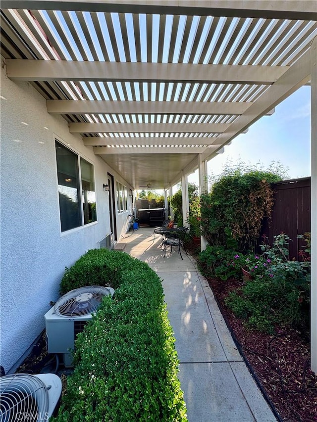 view of patio / terrace with central AC and a pergola