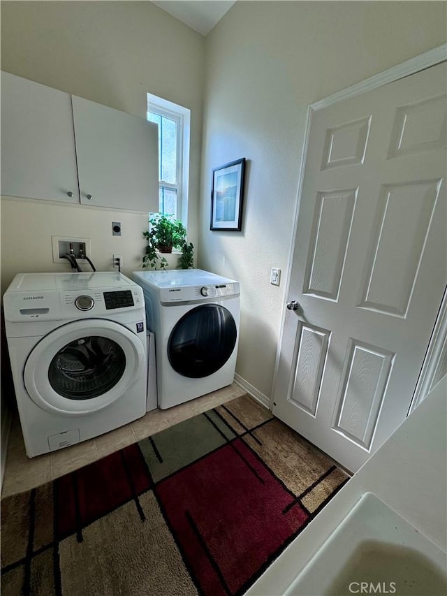 laundry area featuring cabinets and washing machine and dryer