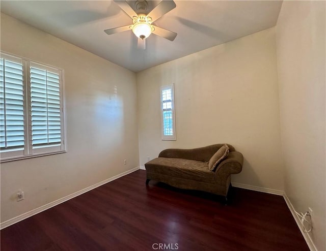 sitting room with ceiling fan and dark hardwood / wood-style floors