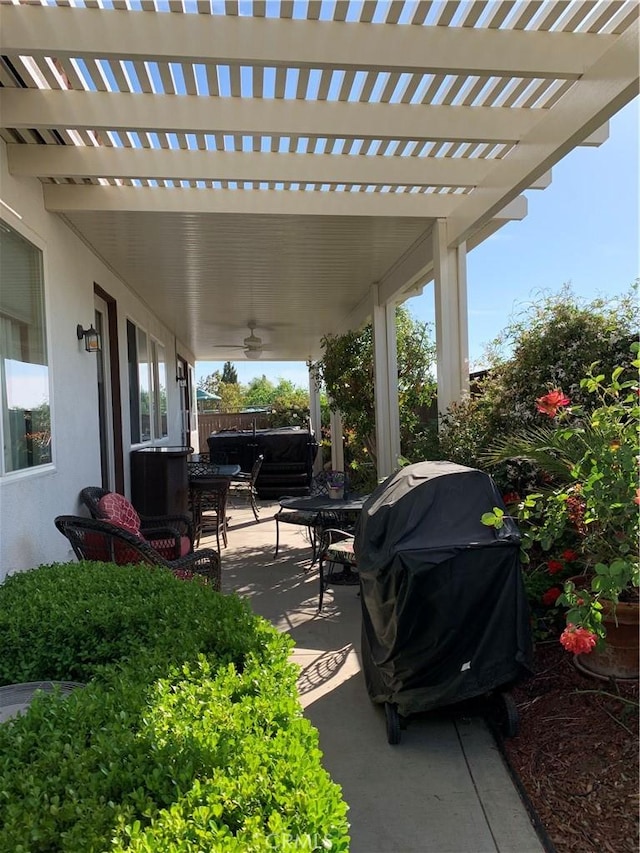 view of patio featuring a hot tub, a pergola, and a grill