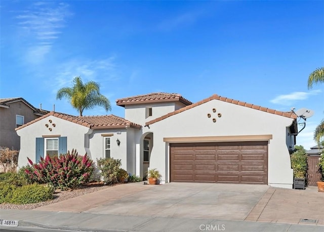 mediterranean / spanish home featuring a garage