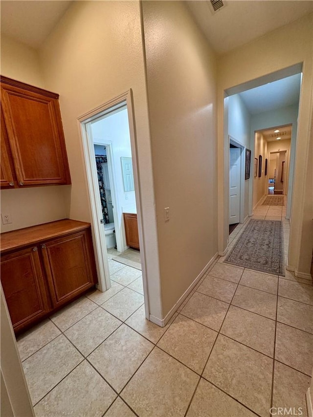 hall featuring light tile patterned flooring