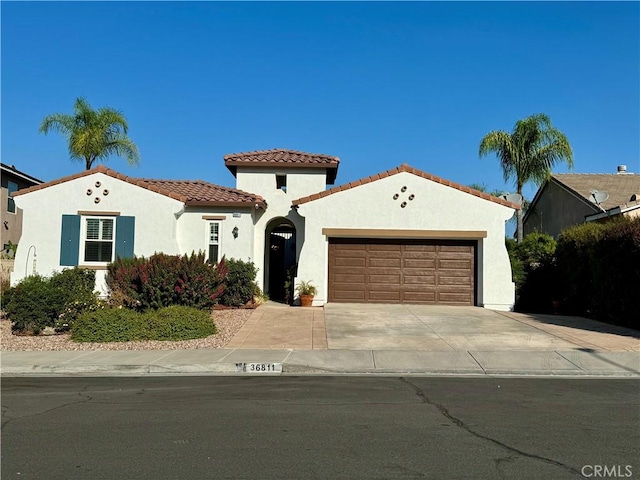 mediterranean / spanish-style house with a garage